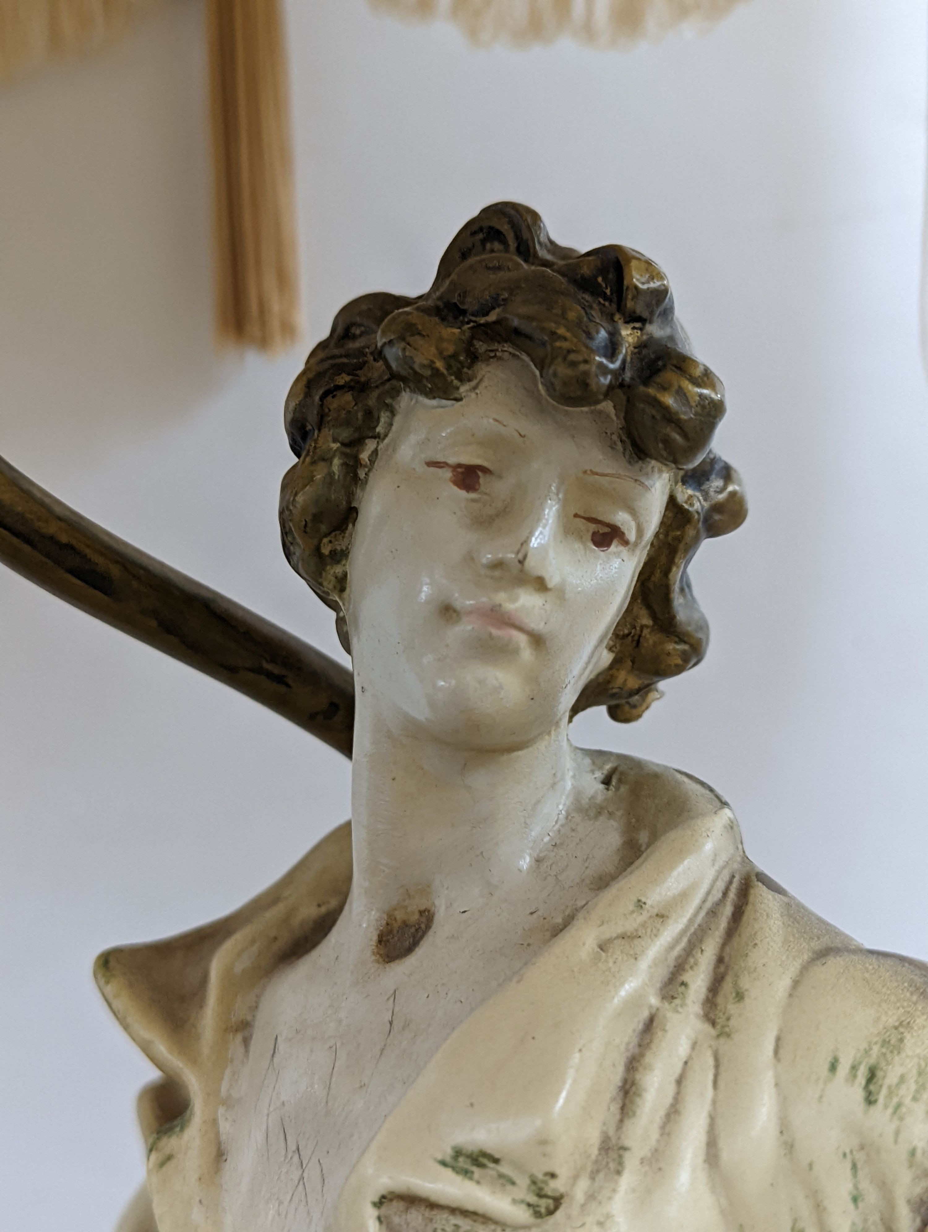 After L & F Moreau - a painted spelter figural table lamp, peasant girl and boy, 96 cms high including shade.